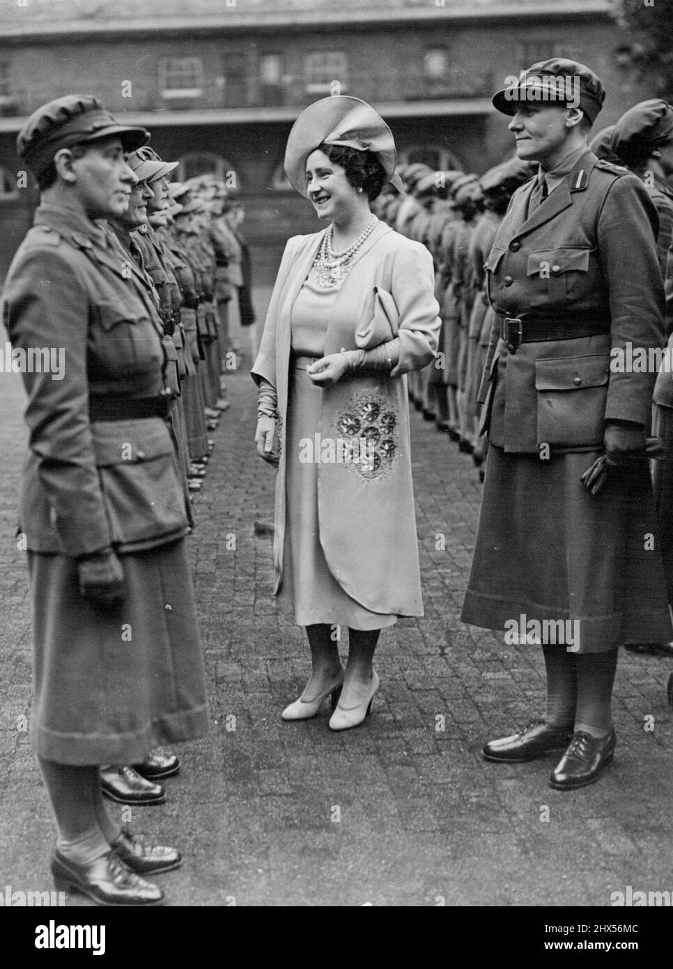 Queen Inspects Women's Legion -- H.M. The Queen inspecting the Women's Legion at the Royal News Buckingham Palace. One a week uniformed women drill at the Royal Maws, Bukingham palace London, and last night they were inspected by H.M. The Queen. They are members of the Women's Legion, the famous corps founded in 1914. The Women's Legion is Voluntary crops which has been included in the Army list since it began in 1914. October 24, 1940. (Photo by London News Agency Photos). Stock Photo