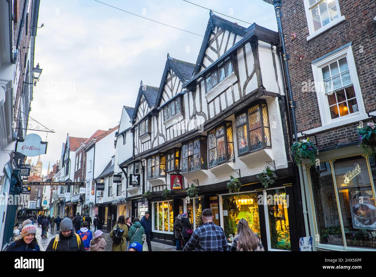 Shopping,old,half-timbered,buildings,along,street,in,York,city,centre,popular,tourist,tourism,attraction,of,in,North Yorkshire,Yorkshire,North East England,England,English,UK,United Kingdom,GB,Great Brtiain,British,Europe, Stock Photo