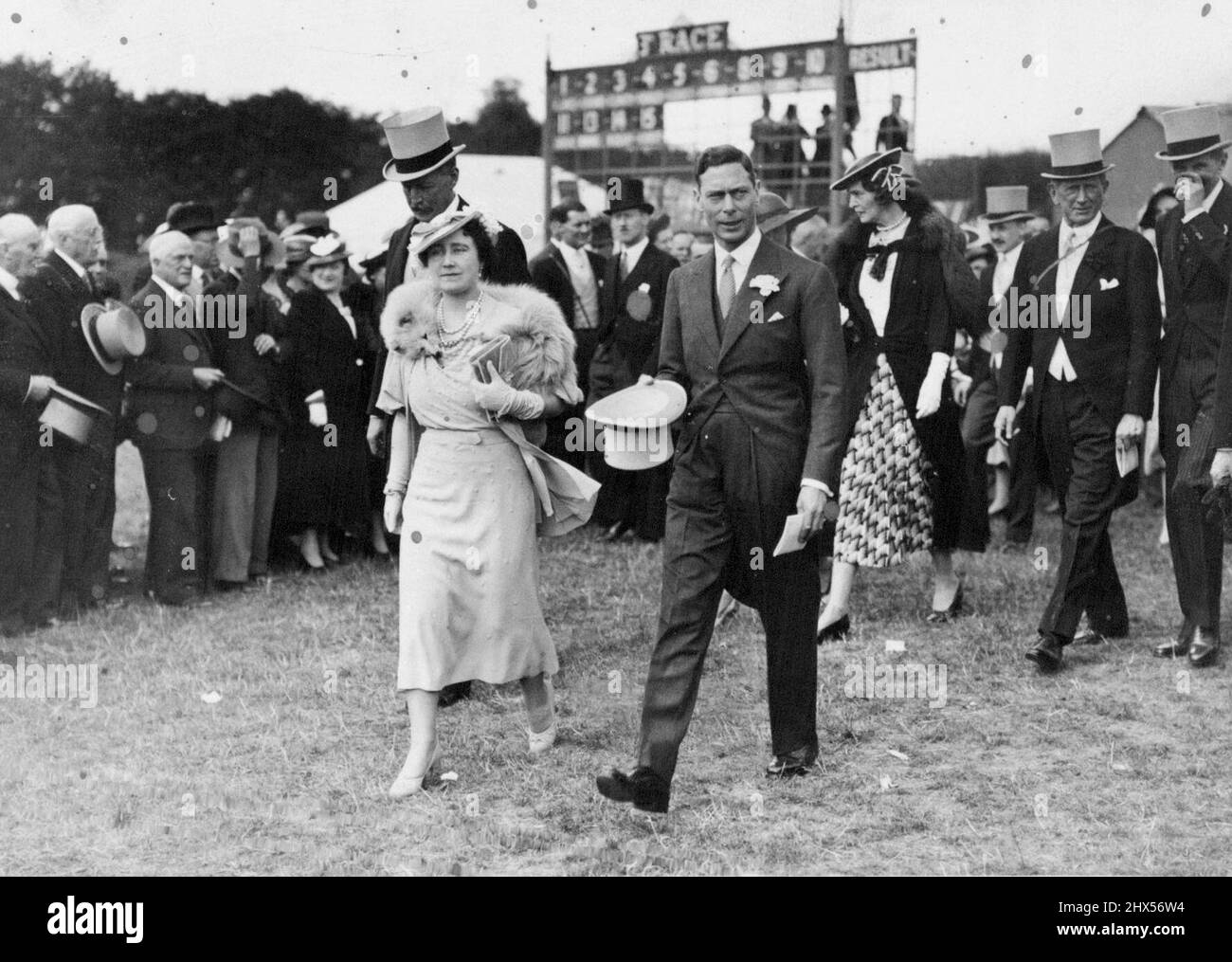 The Oaks: The King and Queen walking in the paddock at Epson, when they were present to watch the Oaks. July 5, 1937. Stock Photo