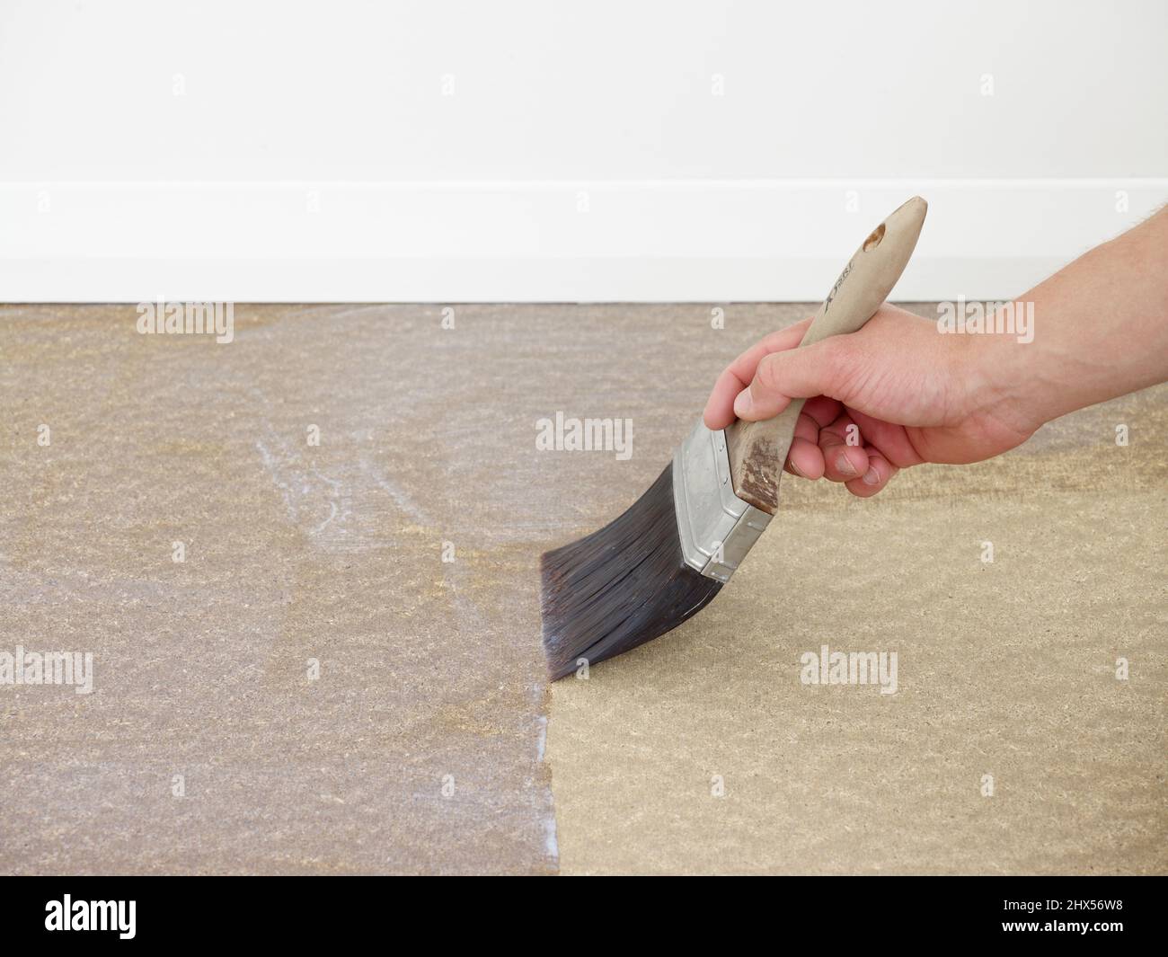 Laying vinyl tile floor, sealing surface of the floor with floor primer Stock Photo Alamy