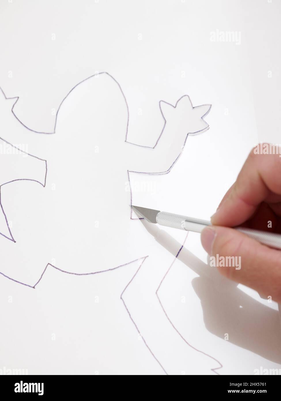 Cutting out stencil shape with a craft knife Stock Photo Alamy
