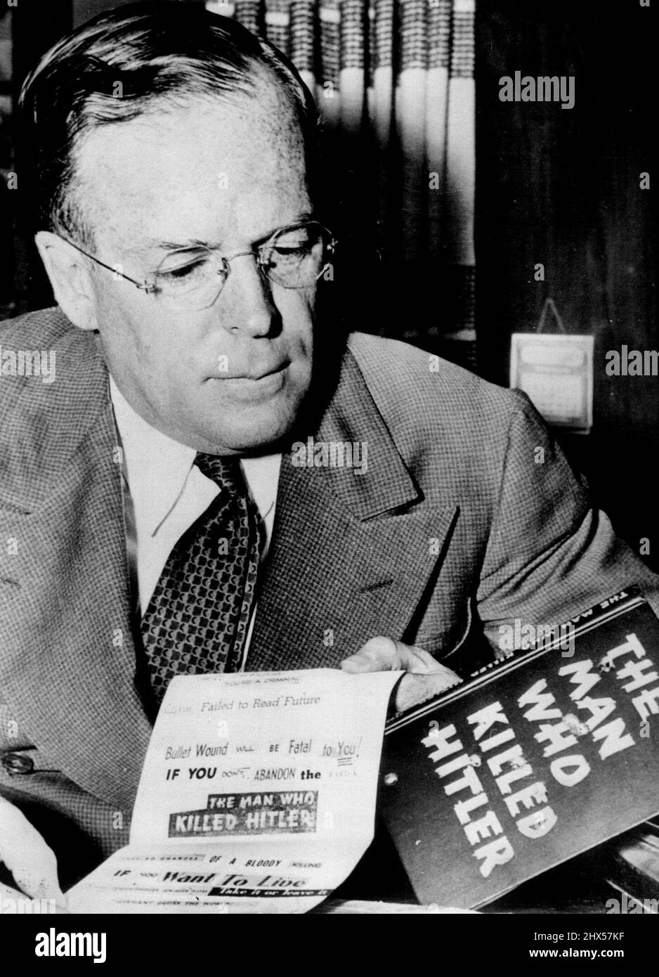 Bullet - Ridden Warning To Publisher Of 'Man Who Killed Hitler' Book -- Putnam holding the bullet ridden copy of the book 'The Man who killed Hitler'. Some weeks ago a book was published in New York by a usually Reputable firm claiming that her Hitler had been killed on the Night before the Munich conference. It claimed to be written by one of the doubles taking der fuether's Part. George palmer Putnam, husband of the late Amelia earhart was the publisher. He was had three ***** warnings. The last was a bullet-ridden copy of his *****. May 15, 1939. Stock Photo
