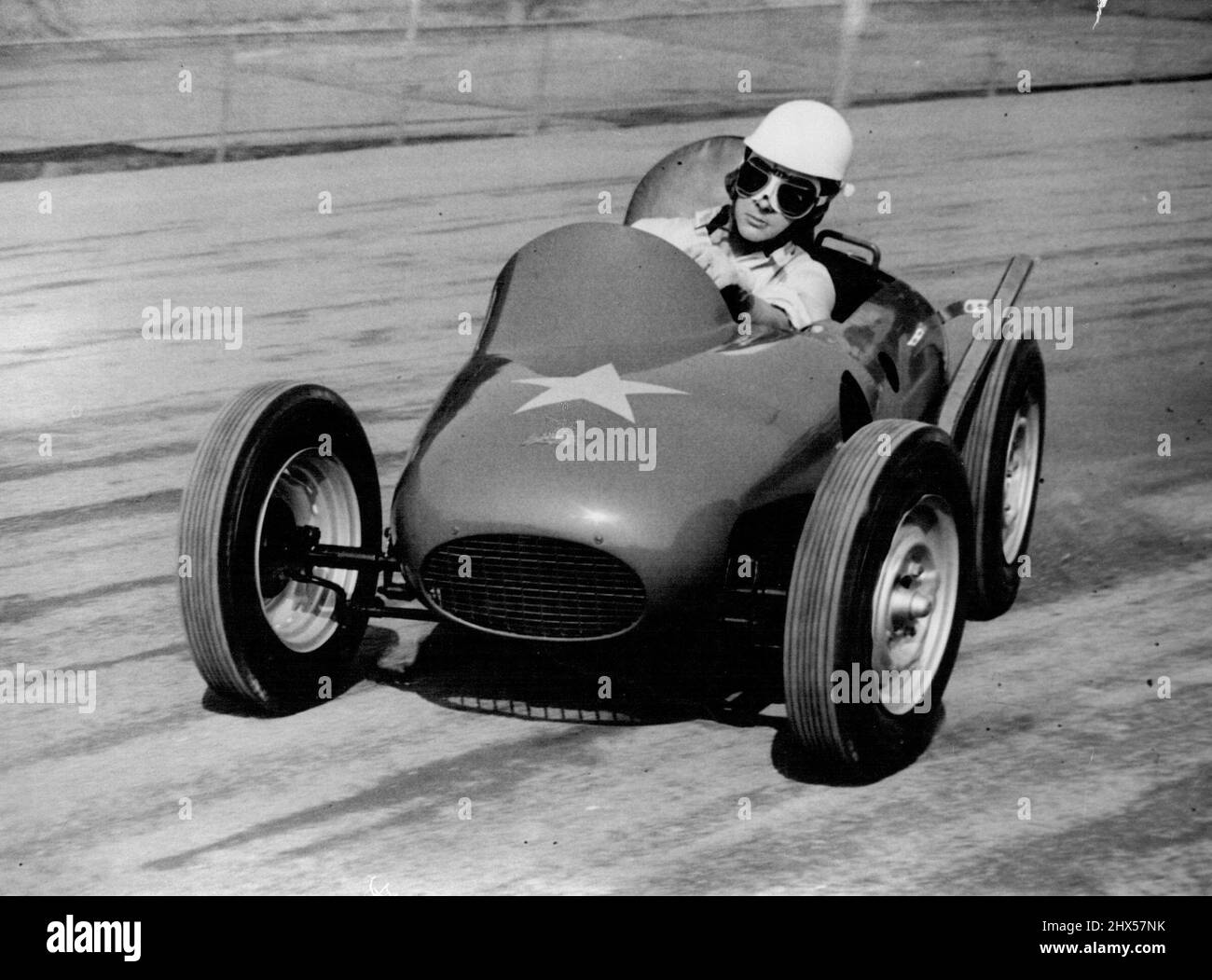 The Atom Racer -- Ronnie Moore, World speedway champion, 1954, speeds round the Wimbledon, London, track in the world's smallest racing car, prototype of a fleat expected to be racing in Britain next year. The car, styled atom-Car is powered by a 500 c.c. Speedway J.A.P. engine, In the first trial of the car the year, the machine over turned and Moore broke his collar-bone. Considered adjustment have since been made to the car. September 20, 1955. (Photo by Reuterphoto). Stock Photo