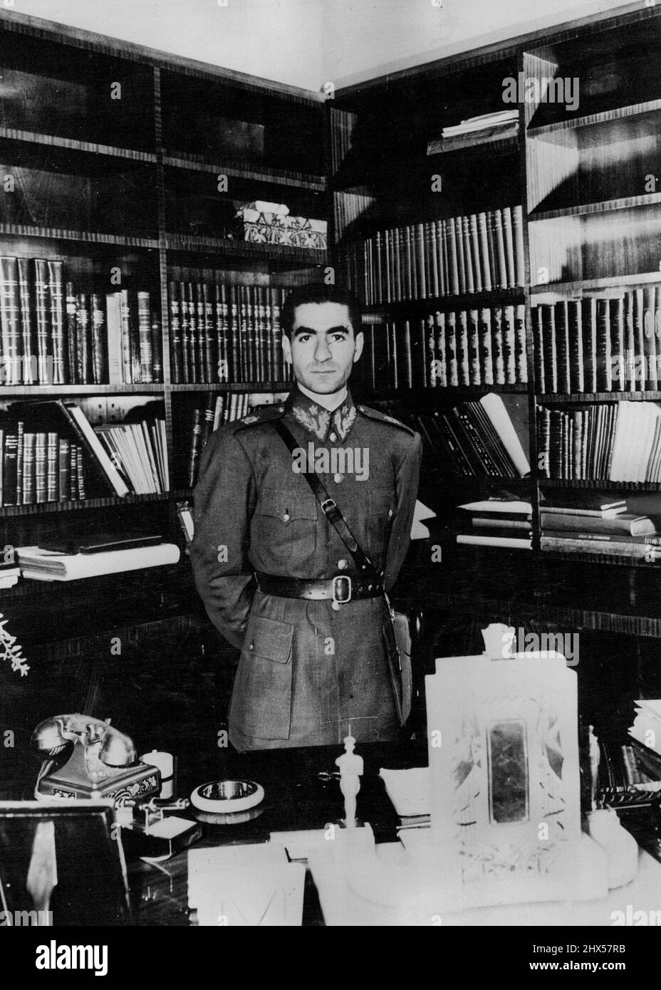 Ruler Of Iran -- Mohammad Reza Shah Pahlavi, King of Iran, photographed in his study in the Royal Palace at Teheran. On his desk (left) is a gold telephone and (right) an elaborate desk - set surmounted by a miniature crown.A 27-year-old King rules over 15,000,000 people whose security and independence have become the subject of World Debate. He is Mohammad Reza Shah Pahlavi, ruler of Iran, who ***** the late Riza Shah, in 1941. The young King was educated in Switzerland and speaks several languages, including English. In 1938 he was married to Fowzieh, sister of King Farouk of Egypt. They hav Stock Photo