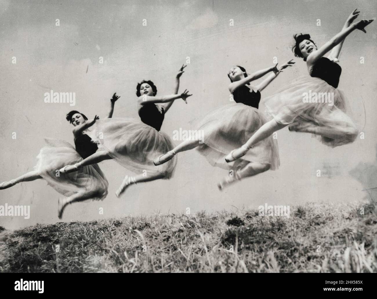 Springs is in the air in Japan. These Japanese ballerinas practice out-of-doors for the first time this year as warm weather comes to Tokyo. March 18, 1955. Stock Photo