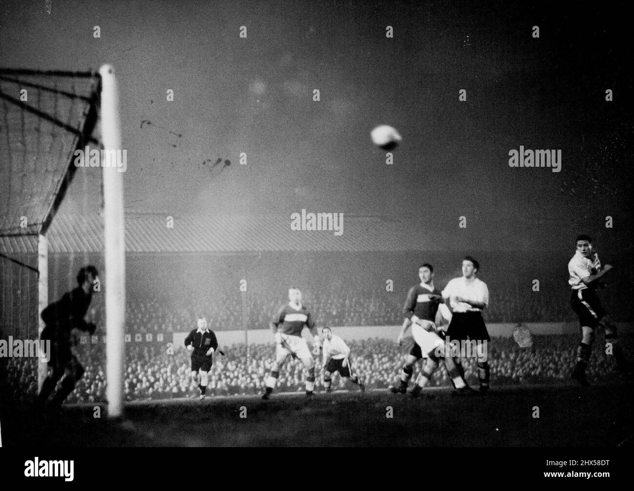 A tense moment as the Spartak Goal comes under fire. Wolverhampton players are in white shirts and black knickers. The Spartak goalkeeper is Michael Piraev. Wolverhampton Wanderers laid low the Legend of Russian invincibility in football last night November 16 when they Defeated Moscow's Spartak team 4-0 in a floodlit match at the Wolverhampton Ground. the last three goals were scored in the final six minutes of the match. November 17, 1954. (Photo by Associated Press Photo). Stock Photo