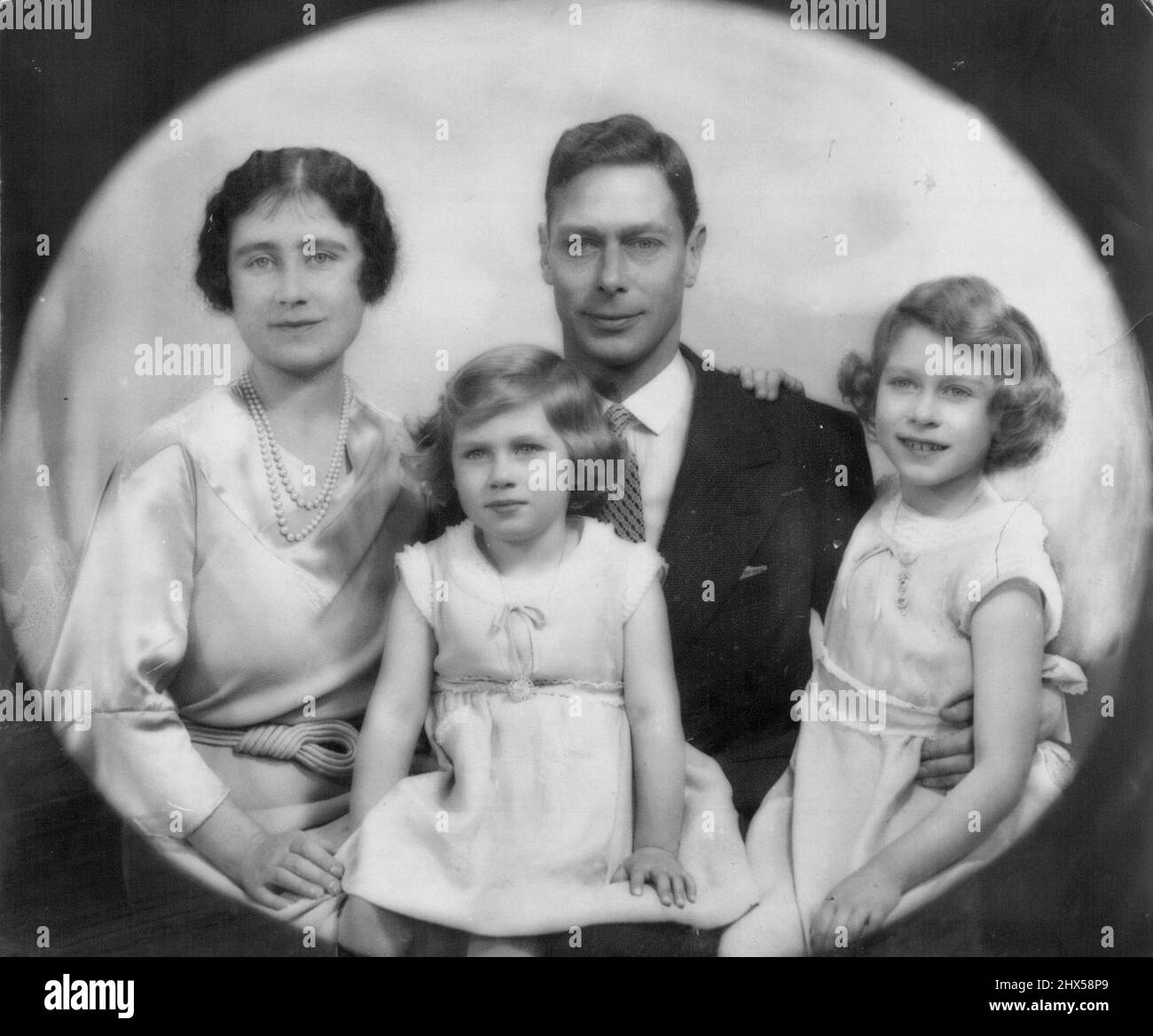 King George & Queen Elizabeth With Princesses Elizabeth & Margaret Rose. January 27, 1936. (Photo by Marcus Adams). Stock Photo