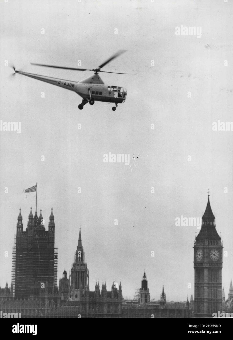 Helicopters Test Festival Site As An Airstop -- A View of the helicopter flying from the Festival site over the river, with the House of Parliament in the background.  The Practicability of the former Festival south Bank site, was an airstop, was tried out today by Bristol 171 and Sikorsky S51 helicopters. The aircraft landed on the Fairway between the sites of the Dome of Discovery and the Transport Pavilion and the object was to test landing techniques on a site in a built-up area and to measure the noise ***** in the Vicinity. July 28, 1952. (Photo by Fox Photos). Stock Photo