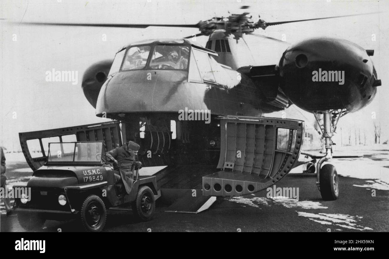 A marine (unidentified) backs in one of three 'mighty mites' into the cargo hold of the new Sikorsky twin engined S-56. The ship is capable of carrying 26 fully equipped marines. January 18, 1954. (Photo by AP Wirephoto). Stock Photo