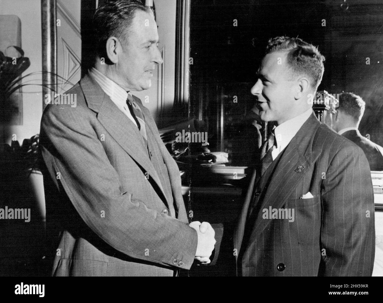 One Cricketer To Another -- Deputy Town Clerk of Sydney (Mr. E.W. Adams) congratulates Arthur Morris, a clerk at the Town Hall, on his selection in the Australian Test team. Mr. Adams formerly played first grade cricket with Morris' club, St. George. November 20, 1946. Stock Photo