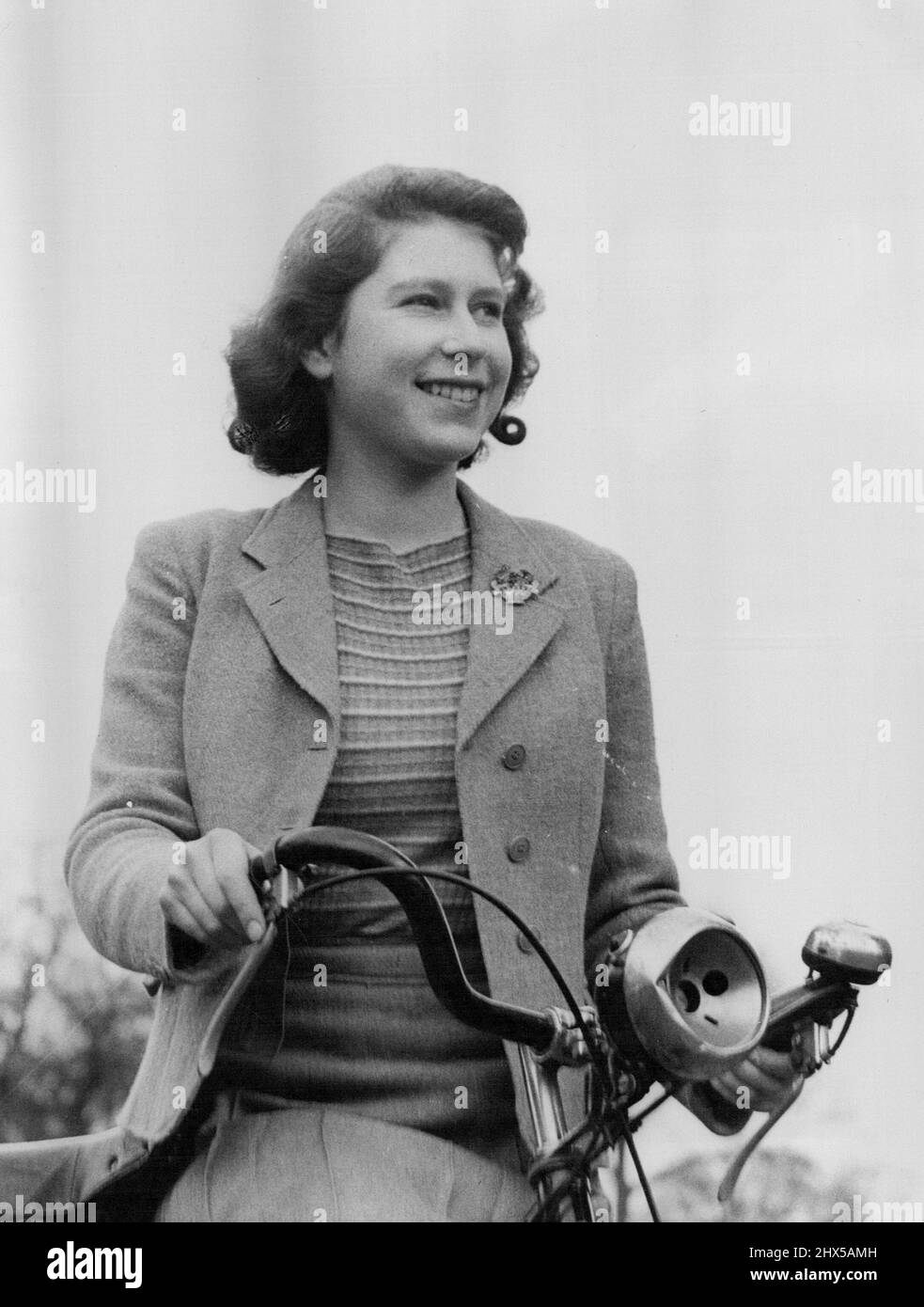 Royal Lodge Windsor April 11th 1942. - Queen Elizabeth with bicycle. June 16, 1953. (Photo by Camera Press Ltd.). Stock Photo