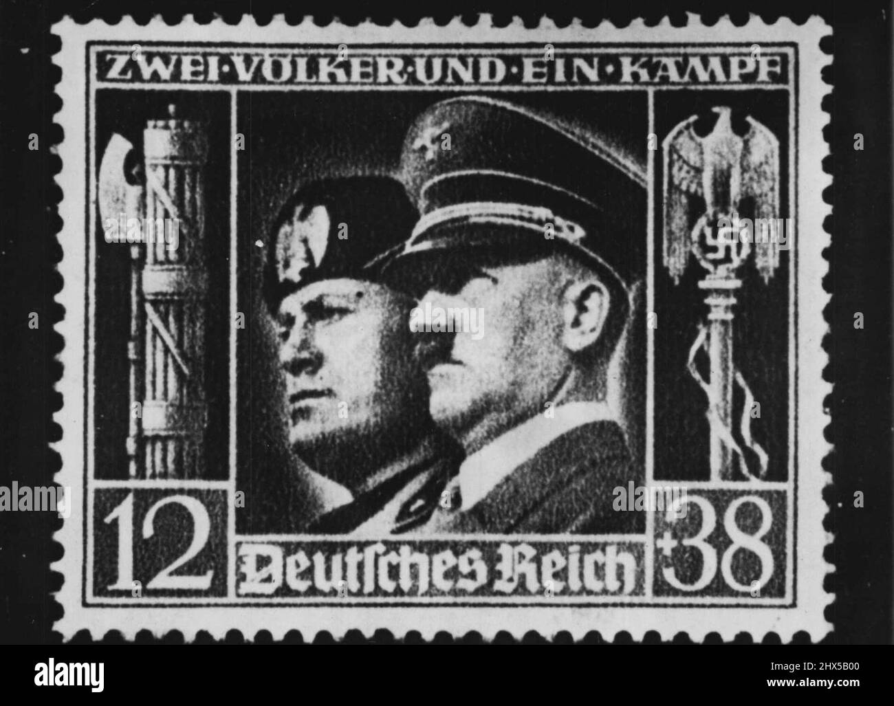 Side By Side -- Axis harmony seems to be borne out in this stamp Newly issued in Germany and bearing the heads of Mussolini and Hitler (Right). The stamp's value is 12 pfenning but there's surcharge of 38 pfennings which goes to Hitler's culture fund. Fifty pfennings equals about 20 cents at exchange rate officially set by the reichsbank. February 19, 1941. (Photo by Associated Press Photo). Stock Photo