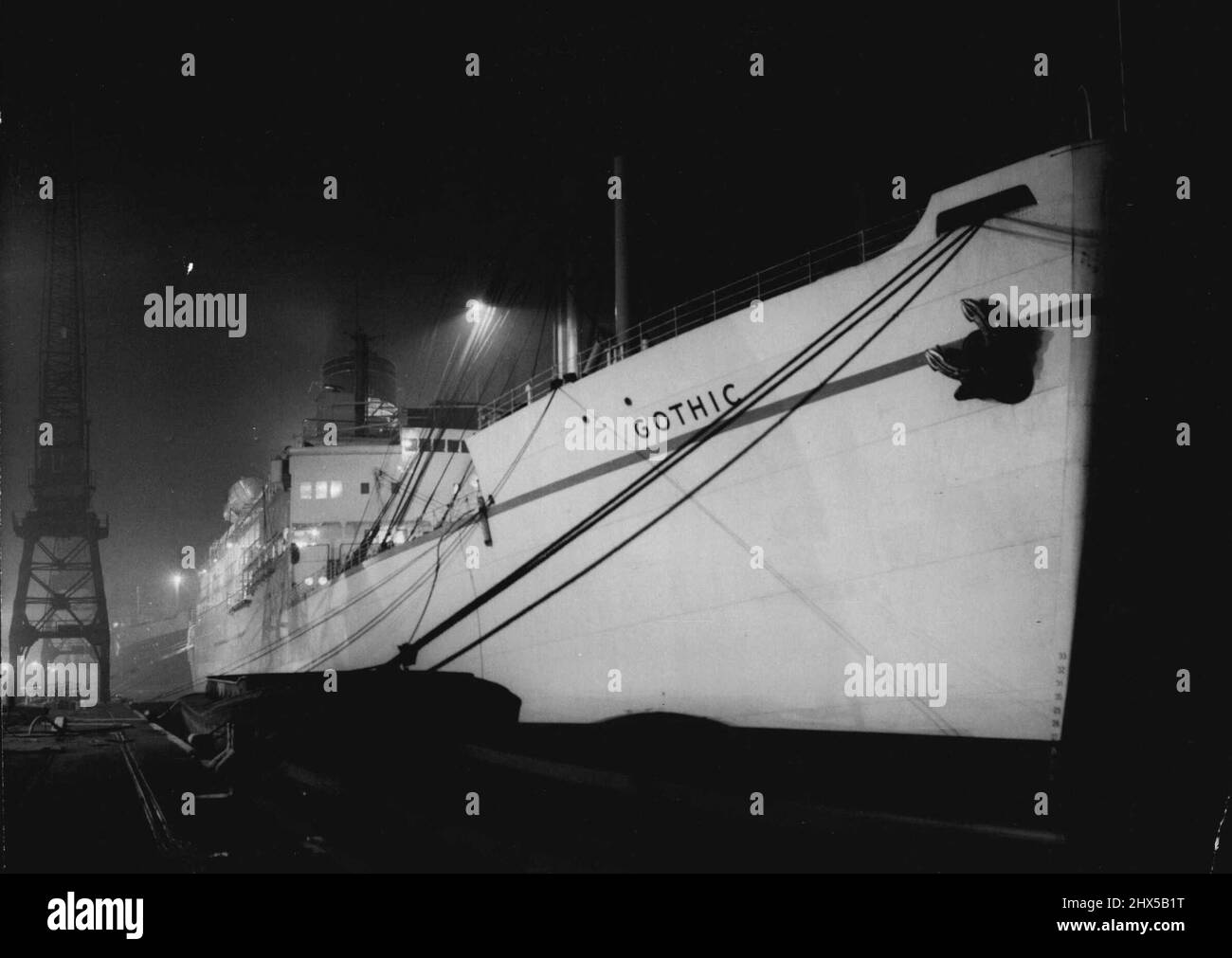 Royal Tour Liner Ready To Sail -- The Royal tour ship, 'Gothic' seen tied up the quay side in King George V Dock tonight Nov. 10th. The Royal tour ship, 'Gothic', her holds battened down and all passengers aboard, was ready at King George V Dock, London, today November 10th, to sail on tonight's tide. Security precautions were in operation as the last of the passengers - members of the households staff, members of the Queen's and the Duke's clerical staff, and press men and women hurried up the single gangway to board the ship tonight. November 10, 1953. (Photo by Associated Press Photo). Stock Photo