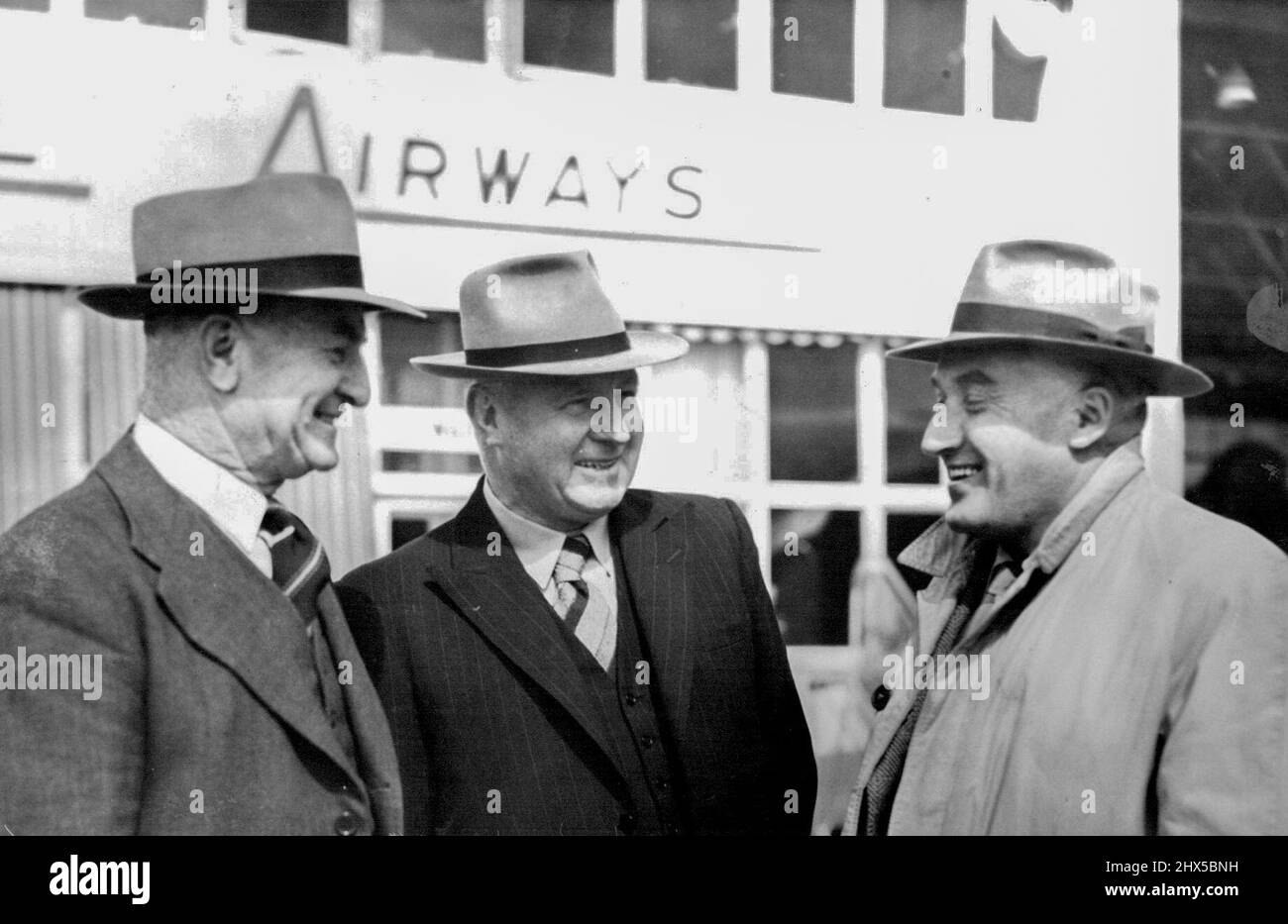 Arrivals from London by air today. The Chief Commissioner of Police (Mr. A. Duncan) - right - being welcomed by Supt. T. O. Morris (left) and Supt. J. O'Keeffe. November 17, 1948. Stock Photo