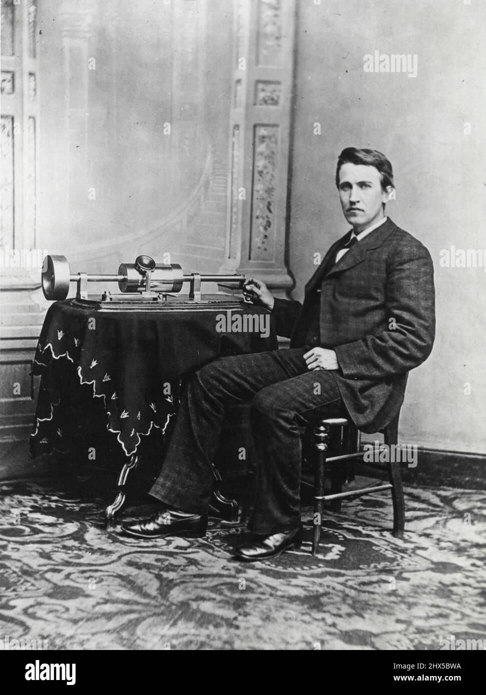 Thomas A. Edison, U.S. Inventor, Helped Develop World-Wide Industries -- Edison's favorite invention was the phonograph. In 1877 while working with an automatic telegraph, he noticed that the device began to hum musically when it was revolved swiftly. From this Edison perfected a method of recording sound vibrations that could be played back and amplified. Edison, then a young man, is shown with the tinfoil phonograph that he exhibited at the National Academy of Science in Washington. June 20, 1951. Stock Photo