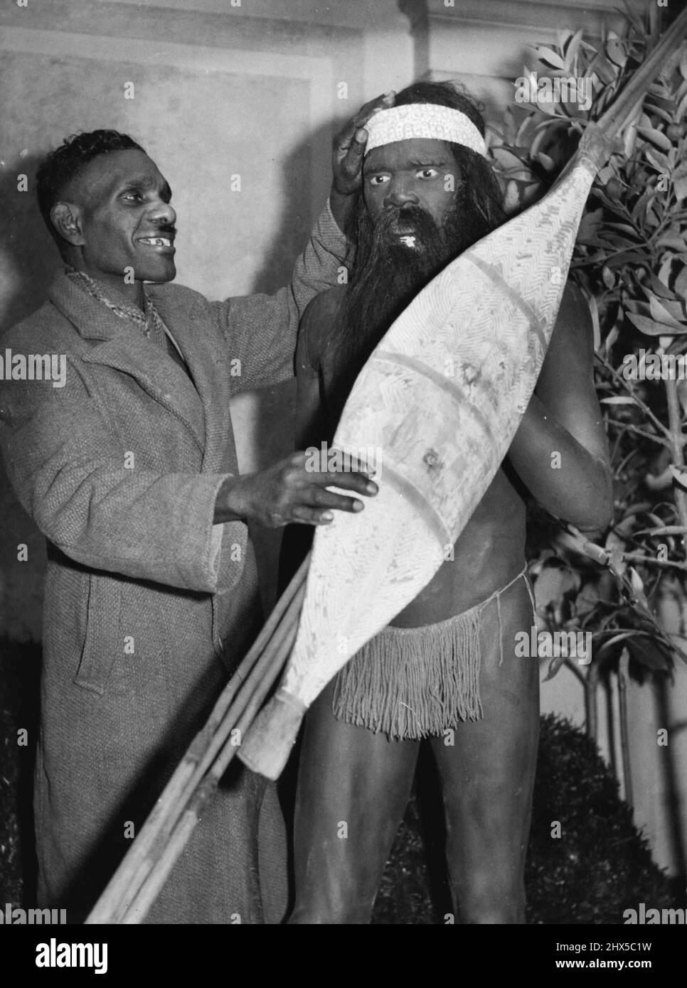 Jimmy James S. Australian blacktracker inspect a life - size aboriginal figurine at the Melbourne N. Territory Exhibition. August 02, 1938. Stock Photo