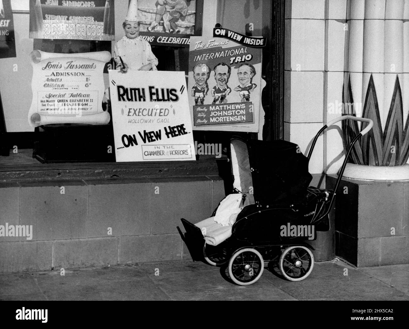 Effigy of Ruth Ellis Draws crowds to Tussauds Waxworks Show at Blackpool -- A Child's pram stands empty outside the Waxwork's, while a poster in the Window announces the attraction. July 14, 1955. (Photo by Daily Herald). Stock Photo