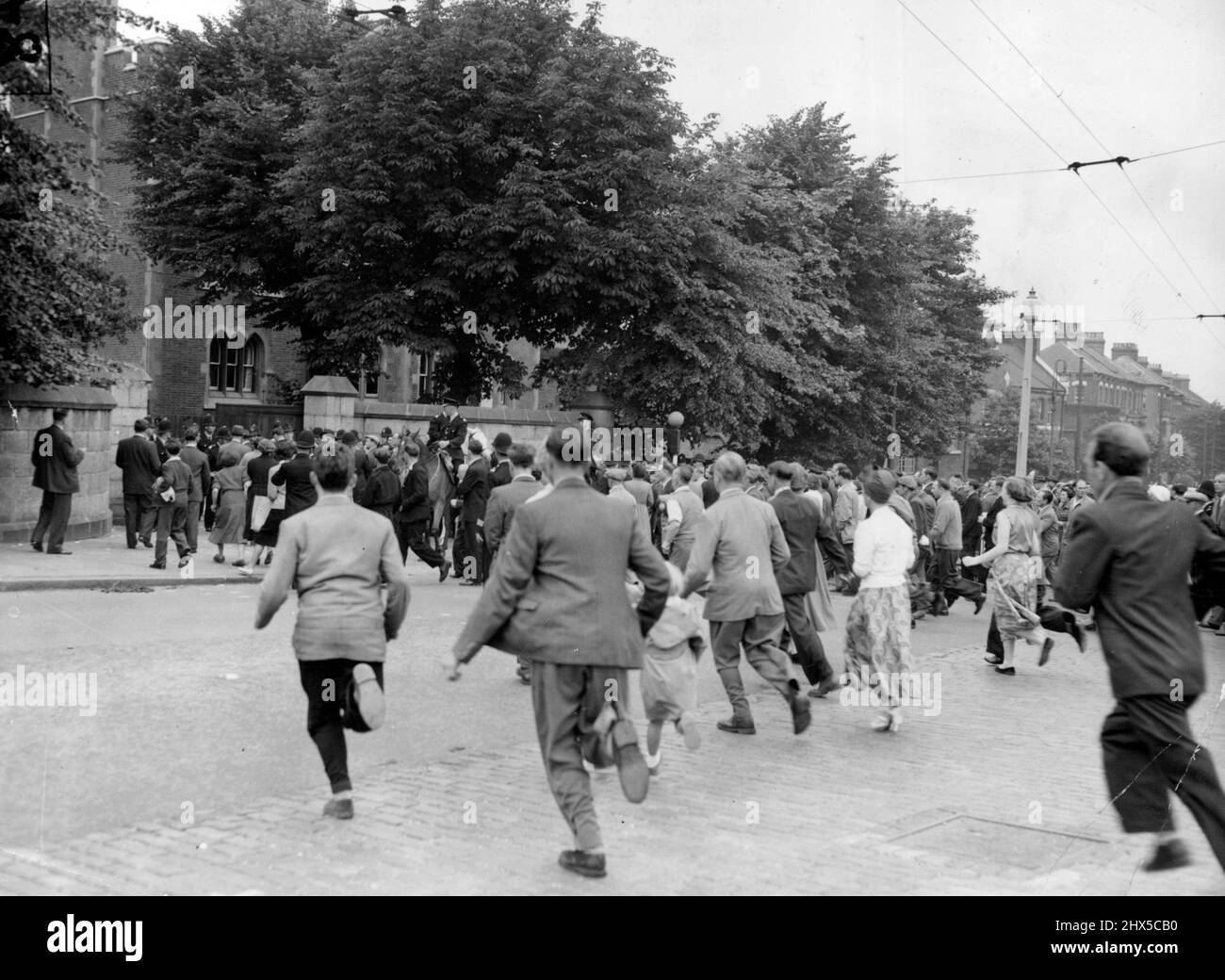 Ruth Ellis Is Hanged -- Crowds Rush across the road at Holloway Prison, London, This Morning July 13 to Read the official notice Saying Ruth Ellis had been Hanged. She was Executed for the Murder of her Lover, David Blakely, a racing motorist, and was the 14th Woman hanged in Britain This Century. Mounted Police were needed to keep the crowds in order outside the Gaol. July 21, 1955. (Photo by Associated Press Photo). Stock Photo