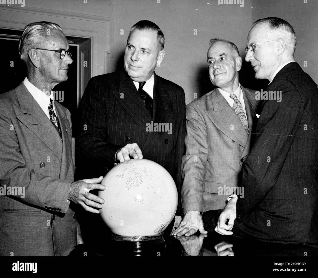 Australian Director General of Post, L.B. Fanning, discusses World-Wide Postal Problems with first Assistant Postmaster General of the United States, Jesse M. Donaldson as he visited the Post office Department in Washington, D.C . Colonel W.G. Wright, Australian superintendent of mails, and John J. Gillen, Acting second Assistant American Postmaster general look on. September 2, 1947. (Photo by Official U.S. Post Office Dept. Photo) Stock Photo