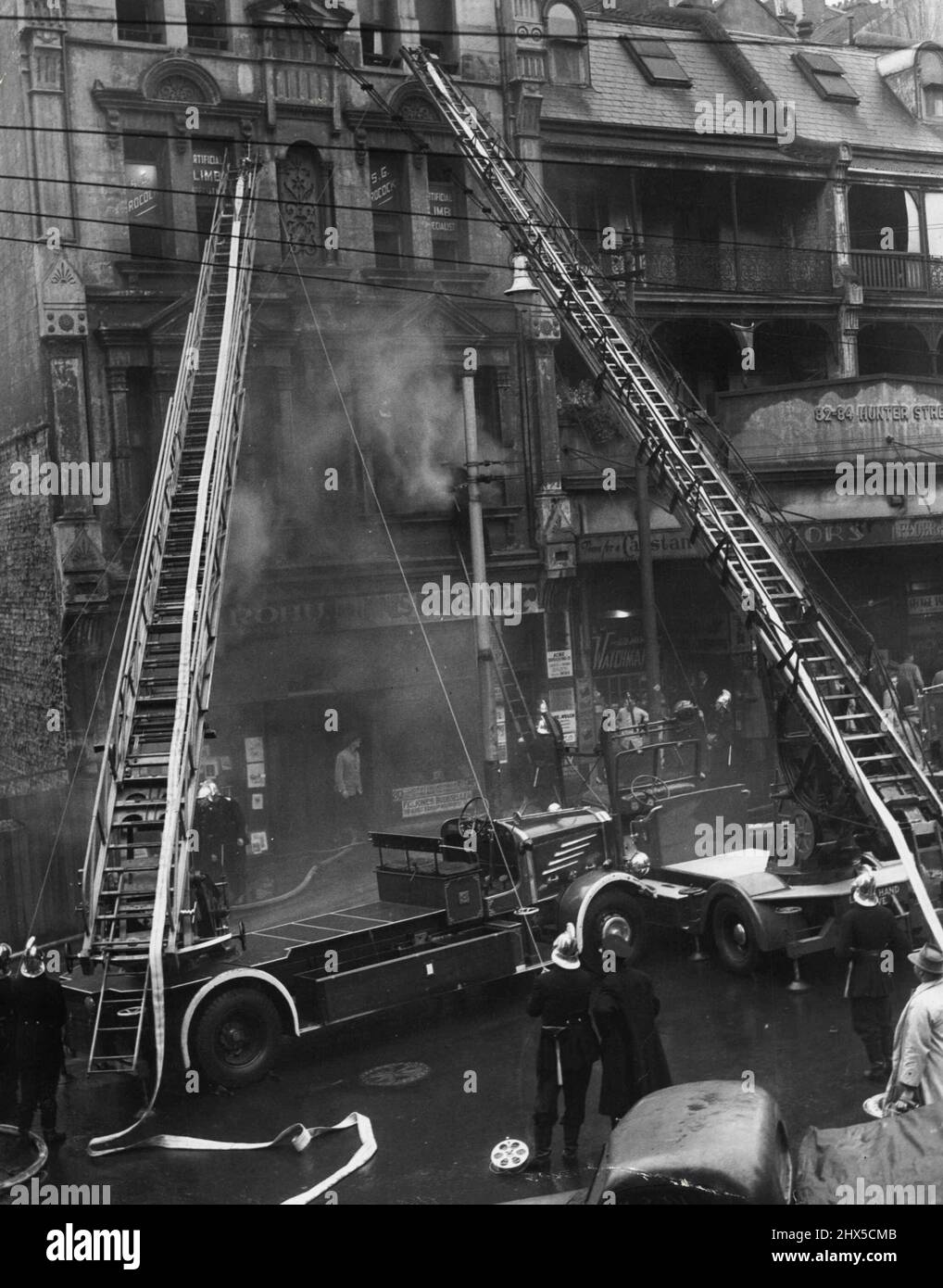 Sabiel building at the Corner of Hunter and Elizabeth ***** where a fire broke out ***** morning. Smoke ***** seen coming from the building as firemen ***** at the extension ladders. June 8, 1951. (Photo by Kenneth Issitt). Stock Photo