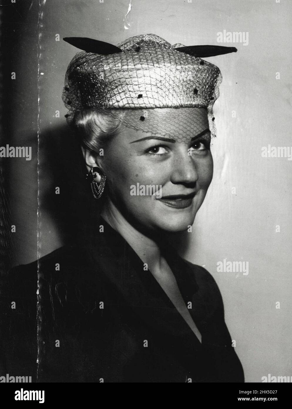 Took a look at platinum blonde 'lovely', Patricia Longlo who's just back from a career as a New York model, and I'd say she's all set for a model's life here. Smart as paint, in a junior navy gabardine suit by Seal Chapman, and little pillbox of champagne satin swathed with gold mesh, she lunched at Prince's she lunched at Prince's with mother, Mrs. G. Hill who's up here from Melbourne. August 24, 1952. Stock Photo