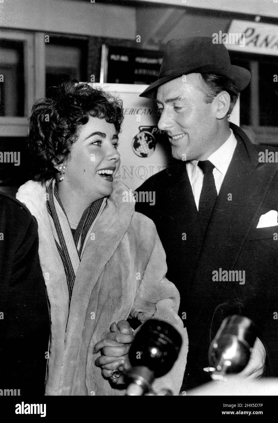 Michael Meets Elizabeth At Airport Wedding This Week -- Happy smiles are exchanged by Elizabeth Taylor and Michael Wilding after the 29-year-old actor had met Elizabeth on her arrival to-night at London airport from America. The couple are expected to marry in London this week-possibly at Caxton Hall. Miss Taylor will be 20 on February 27. Both she and Michael Wilding have been married before. February 19, 1952. (Photo by Planet News) Stock Photo
