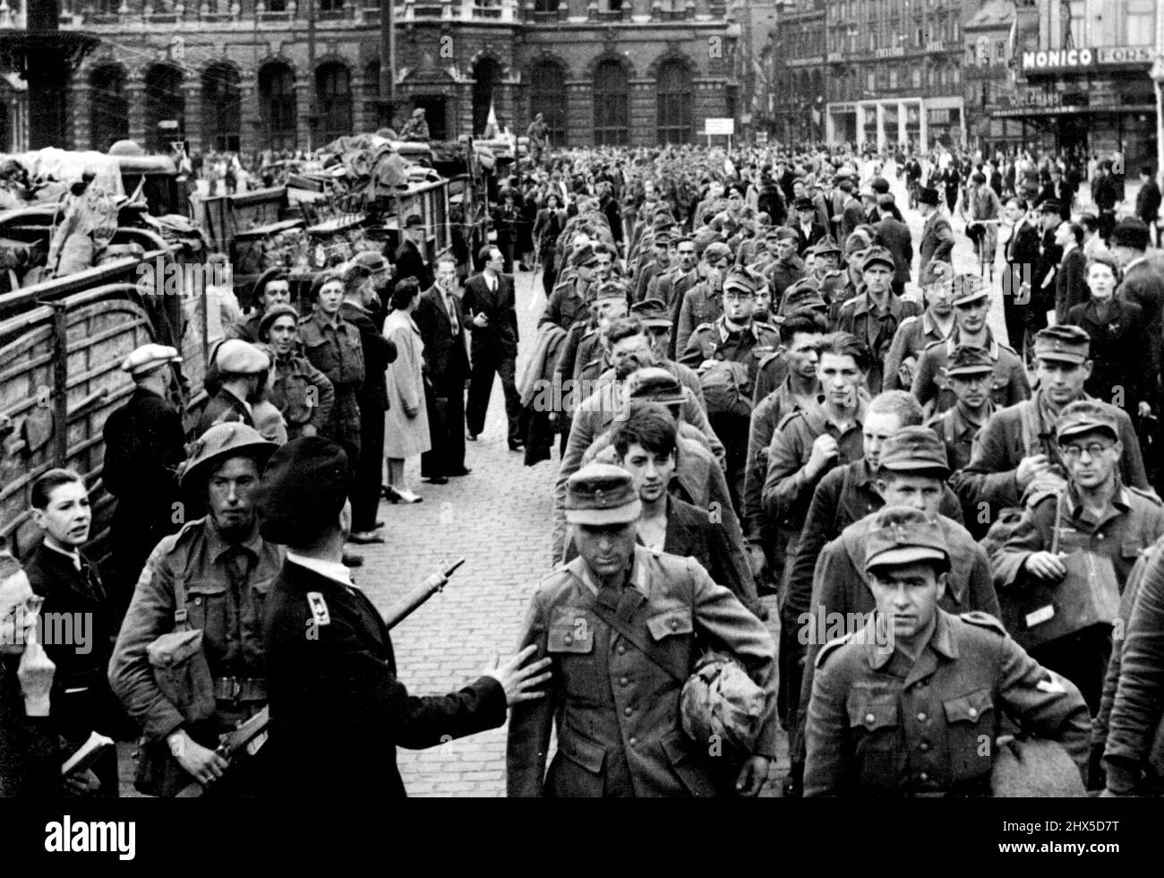 German Prisoners and Belgian collaborators Rounded up as British capture Antwerp -- German prisoners being marched through the streets of Antwerp, with the Central station in the background. Racing beyond newly-liberated Brussels, three flying columns of British armour drove for Antwerp. The speed of the advance took the German defenders by Surprise, and by midnight on Sept 4th capture of Belgium's greatest pert had been announced. September 1, 1944. Stock Photo