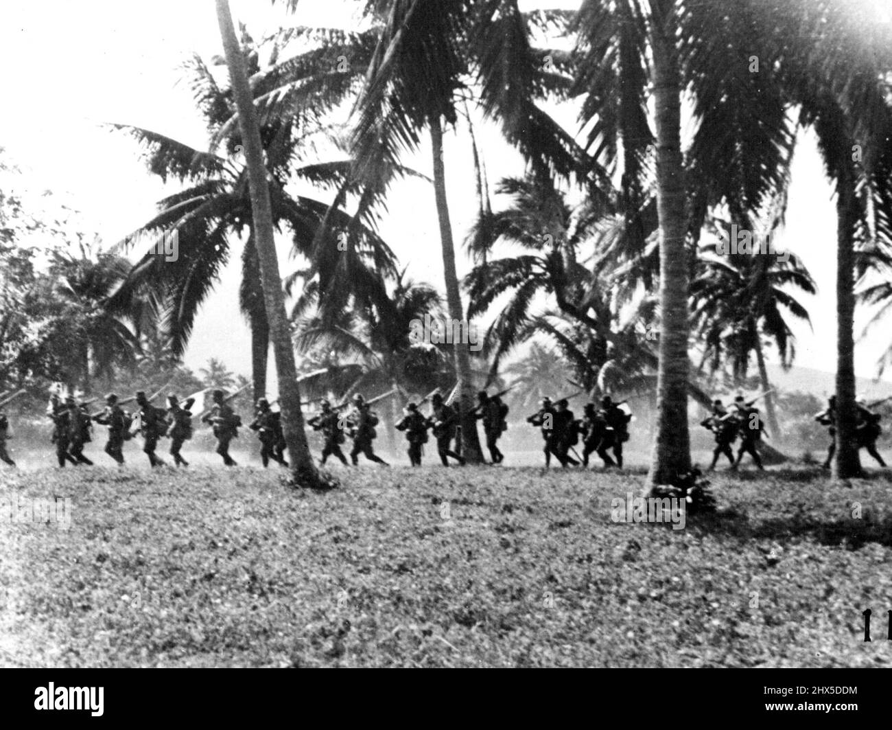 *****... A Japanese insurgent is seen as pursuing the Chinese remnants under the tropical trees. Bishop Scharmach's reminiscences, 'This Crowd Beats Us All' is published by the Catholic Press Newspaper Co. Ltd. February 25, 1939. (Photo by The Domei News Photos Service). Stock Photo