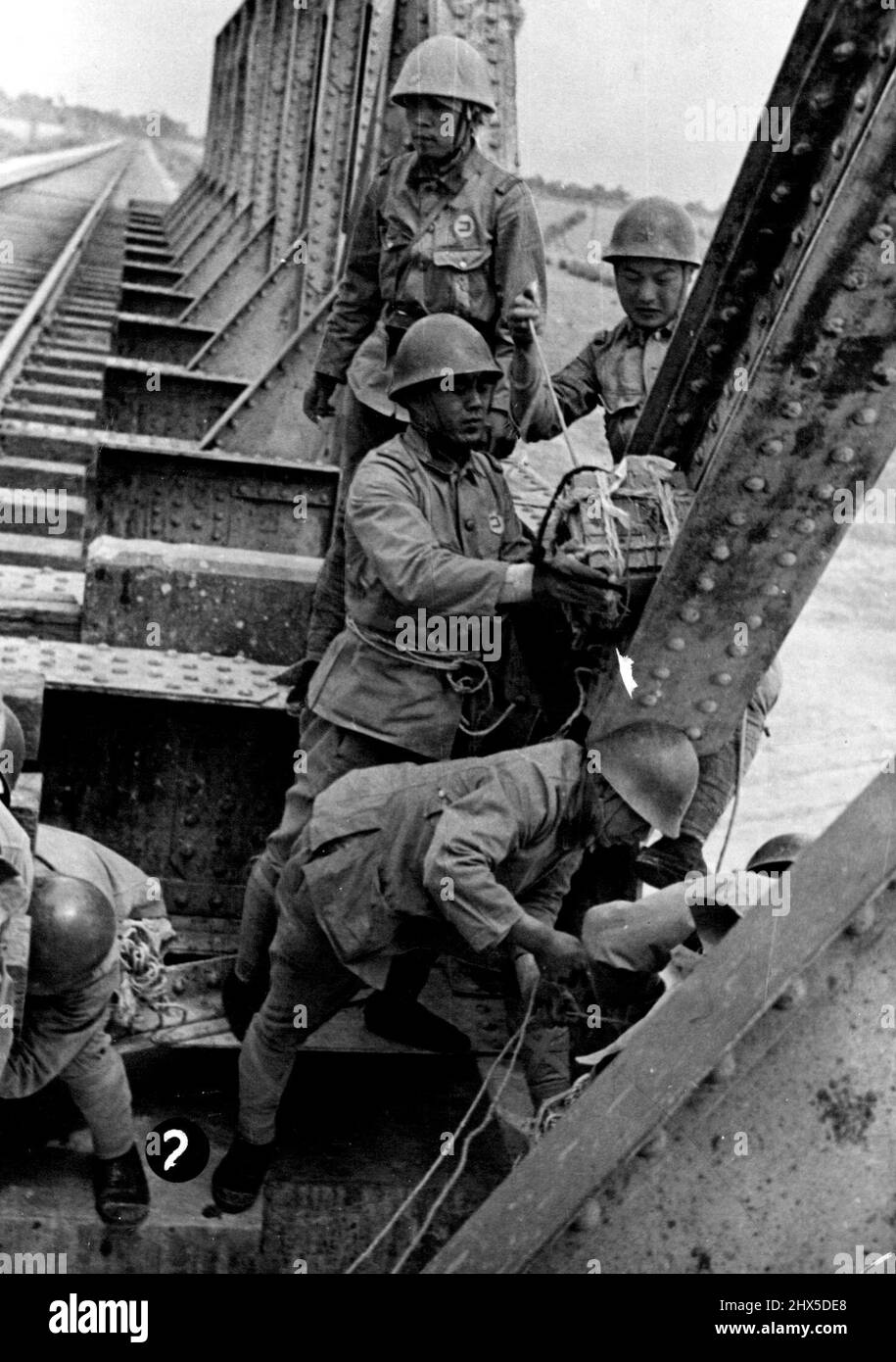 Jap. Engineers place explosives on a bridge at Longhai Rlwy. June 10, 1938. (Photo by Press Union Photo). Stock Photo