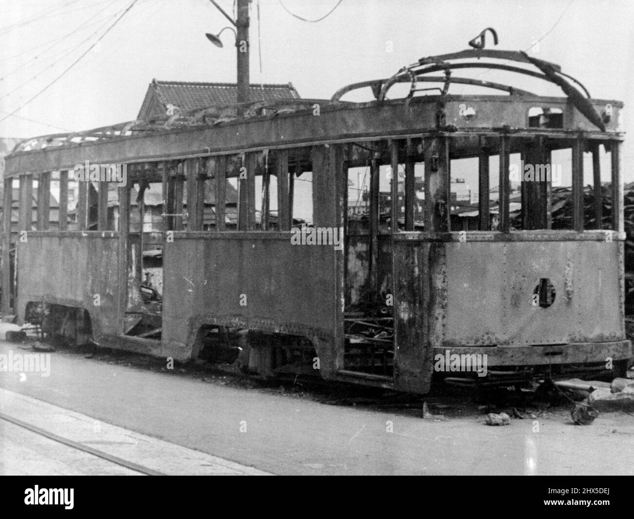 A badly battered electric tram car in Yokahama. This was one of many cars made unserviceable by Allied air raids. Although trains and trams were running when the Allied troops entered the city, the transport system was in a bad condition, and many of the vehicles were worn out. September 10, 1945. (Photo by Australian Official Photo). Stock Photo