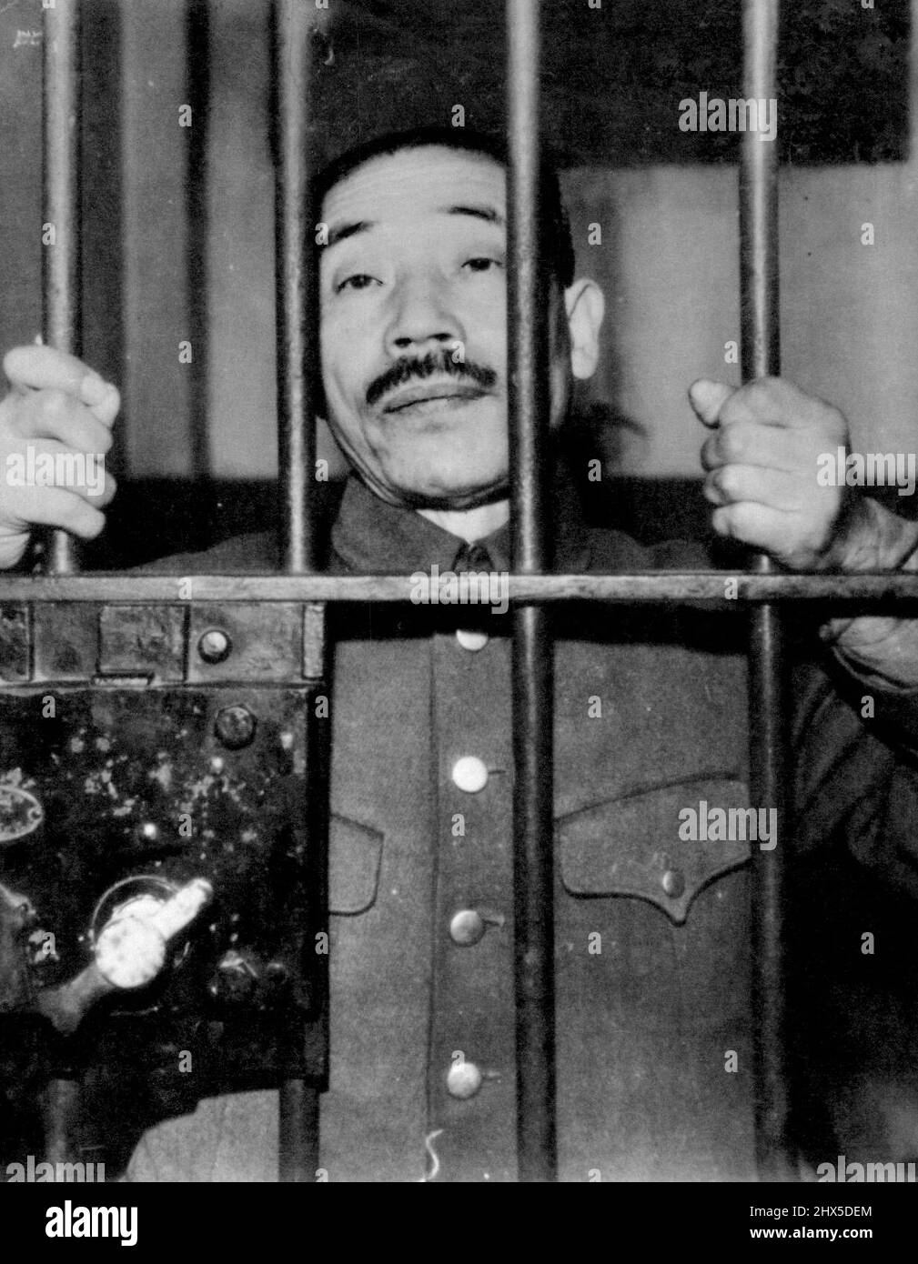 From Behind Prison bars in Shanghai, Captain Sotojiro Tatsuda awaits his trial as a war criminal. Tatsuda was identified by an American airman as the commanding officer of the firing squad which executed three of Doolittle's Tokio attack force. February 14, 1946. Stock Photo