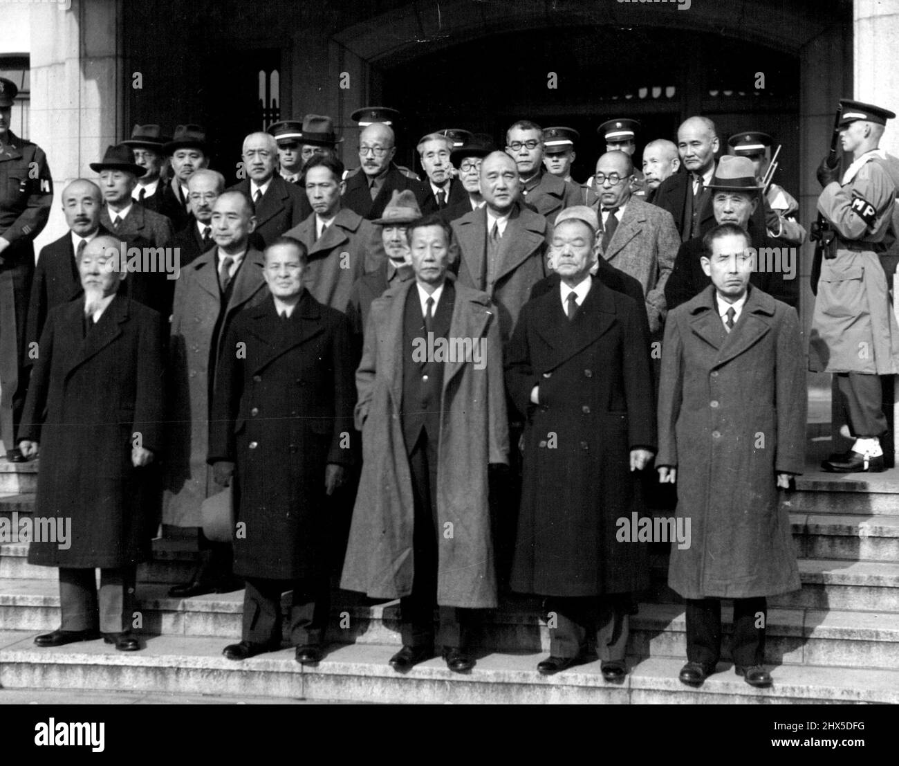 Jap War Crimes Defendants in Group : This is the first group picture of high ranking military and other Japanese officials as they posed for a new year's photograph on the steps of the International Military tribunal for the far east, Tokyo where they are being tried on war crimes charges. Hideki Tojo, Former Premier and No. 1 Japanese on trial is fifth left, top row (bald, wearing glasses). January 6, 1948. (Photo by Associated Press Photo). Stock Photo