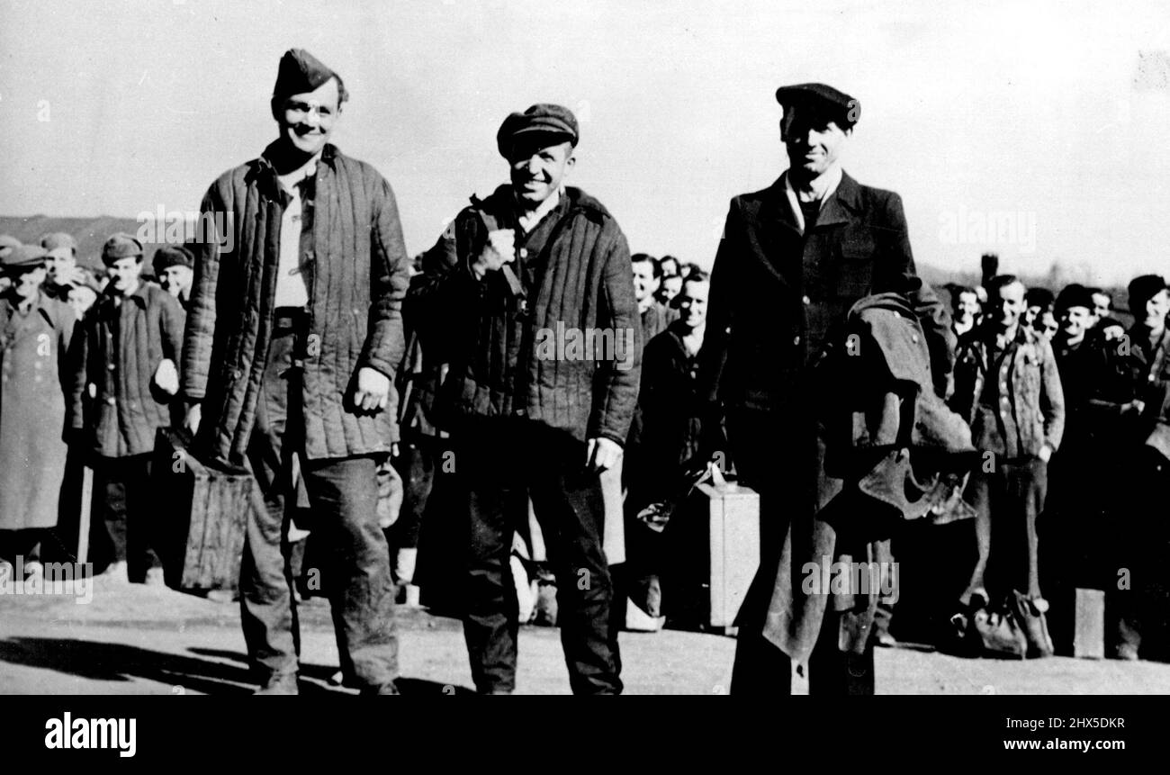 P.O.W. 100,000 returned from Russia : Franz Bauer (centre) is pictured with P.O.W. 99,999 (left) and P.O.W 100,001 at the Hof/Moschendorf transit camp, Germany. Franz Bauer, 35, of POS No, Germany, enjoys the doubtful distinction of being the 100,000th German prisoner of war to be returned from imprisonment in Russia. He arrived, April 2, at Hof/Moschendorf, Germany's largest Transit camp. January 01, 1949. (Photo by Associated Press Photo). Stock Photo