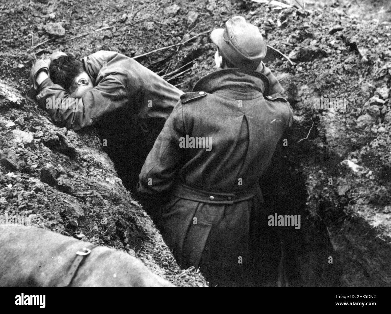 No Doubt about it this Time : The German army is being given a lesson it escaped in 1918, and no future warmonger will be able to deny the completeness of the Reichswehr's defeat in the field. Fought to a standstill these Nazis on Montgomery's front at Emmerich wait in their slit trench while armour and supplies roll on into Germany. March 31, 1945. (Photo by Gaiger, Planet) Stock Photo