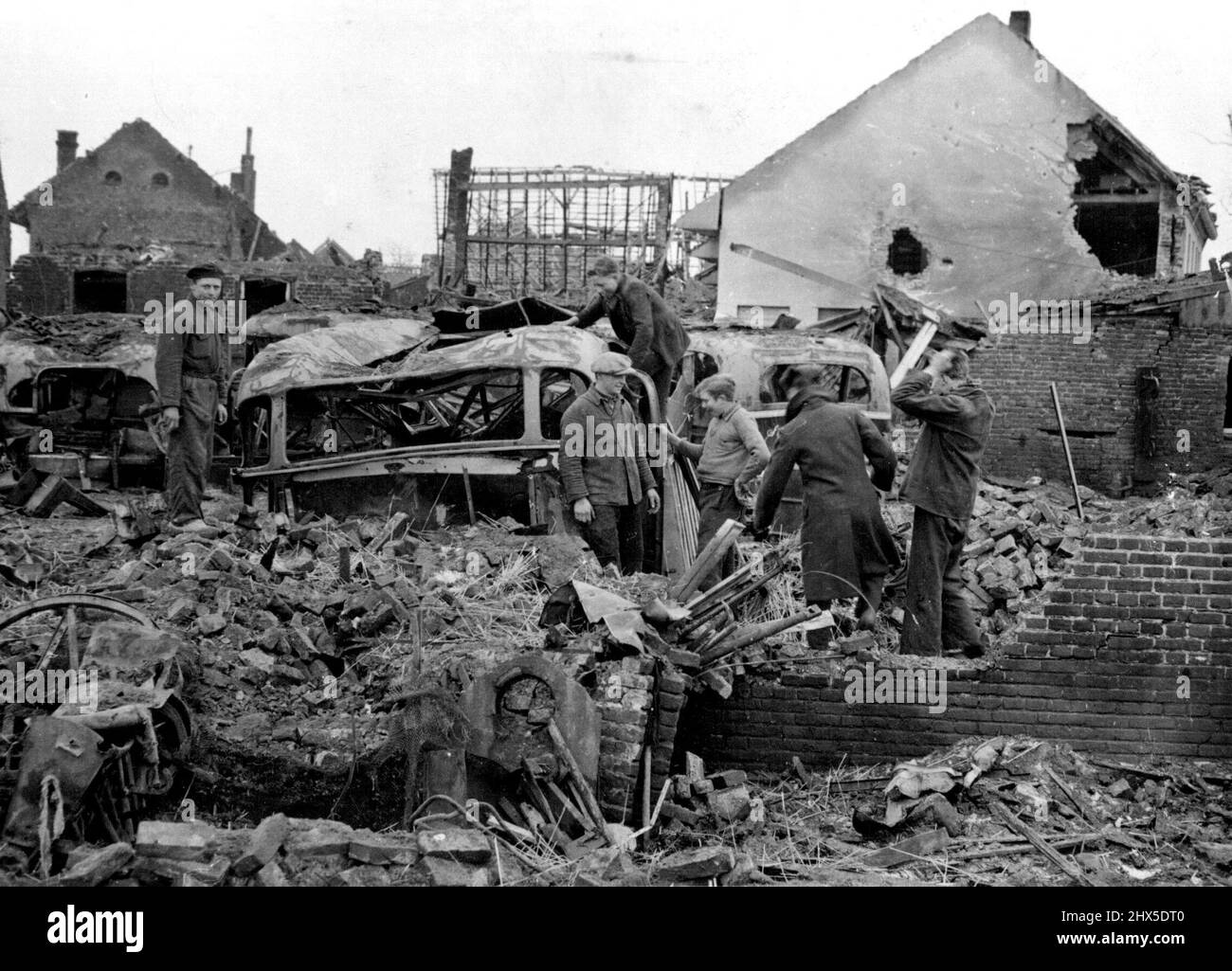 R.A.F. Typhoons Smash German Strongpoint : Wrecked motor coaches in Montfort. Montfort, a Dutch town South of Roermond and east of Echt, was a German Strongpoint until the R.A.F., were called into attack it. R.A.F. Rocket-firing Typhoons did so much damage that the Germans were forced to evacuate the town and British troops marched in. May 14, 1945. (Photo by British Official Photograph). Stock Photo