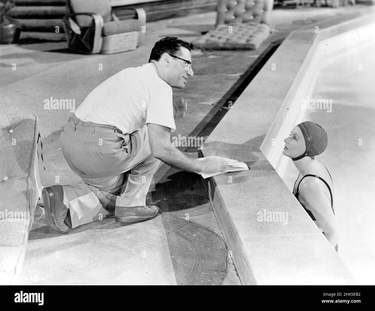 Garbo Swims ... And director George Cukor sees that she does it correctly in her latest Metro Goldwyn - Mayer Comedy, opposite Melvyn Douglas. Featured are Constance Bennett, Ruth Gordon, Roland Young, and Robert Sterling. Gottfried Reinhardt Produced. November 3, 1947. Stock Photo