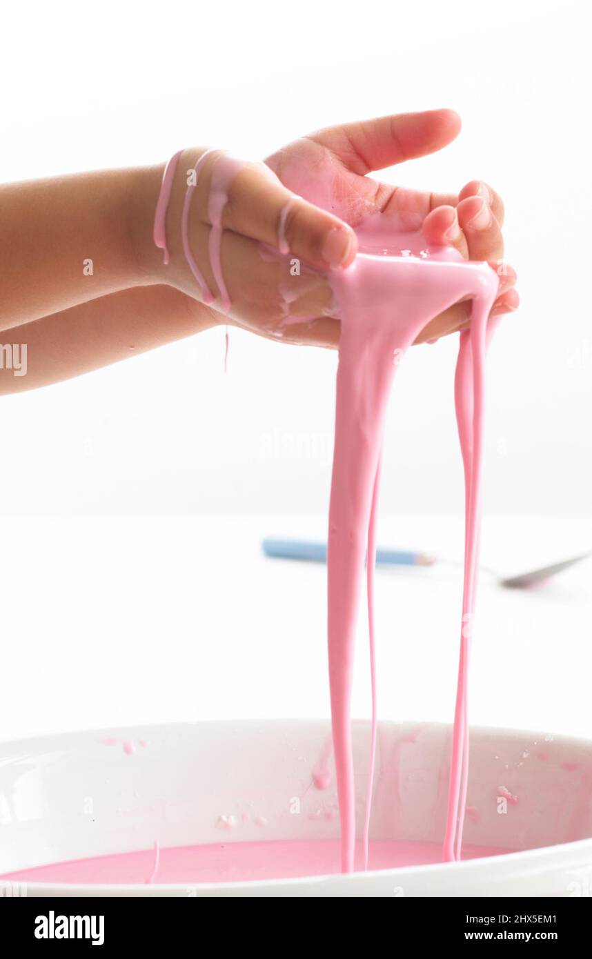 Child with hands covered in pink goo, closeup Stock Photo Alamy