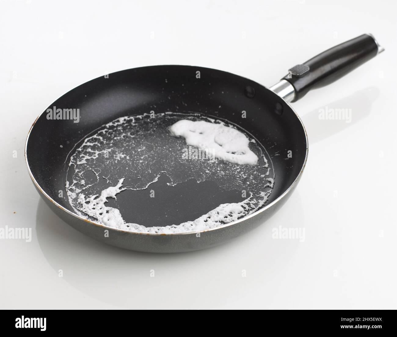 Close-up of frying pan with egg white stuck to bottom Stock Photo