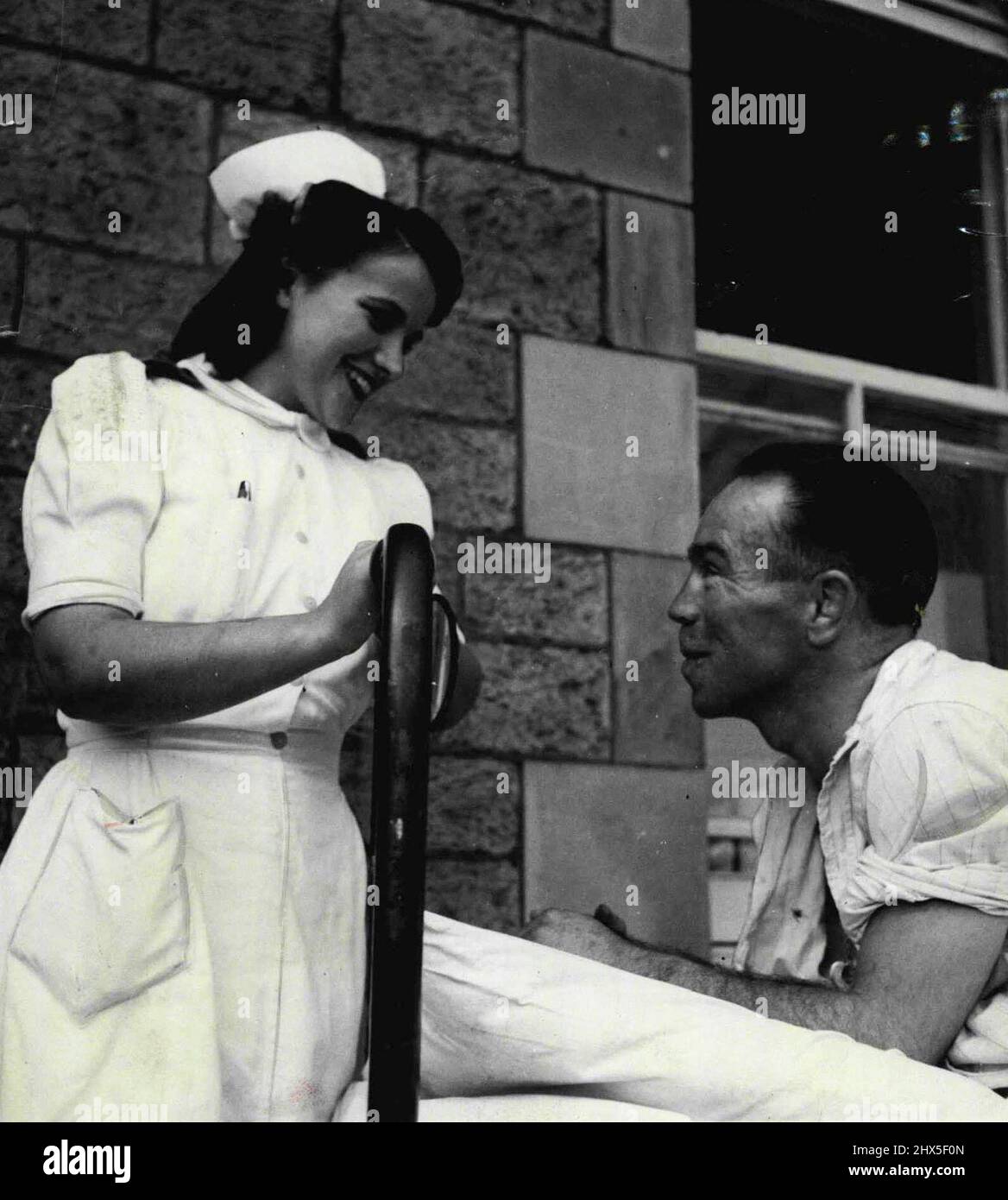 ***** lying on a ***** with his broken spine in plaster of Paris, went 800 miles there and back by ambulance recently from Bridgend (Wales) to Bodmin (Cornwall) to consult a faith healer. Morris, here seen with his nurse, had 300 fights and has been bedridden in hospital three years after a mine accident. August 10, 1947. Stock Photo