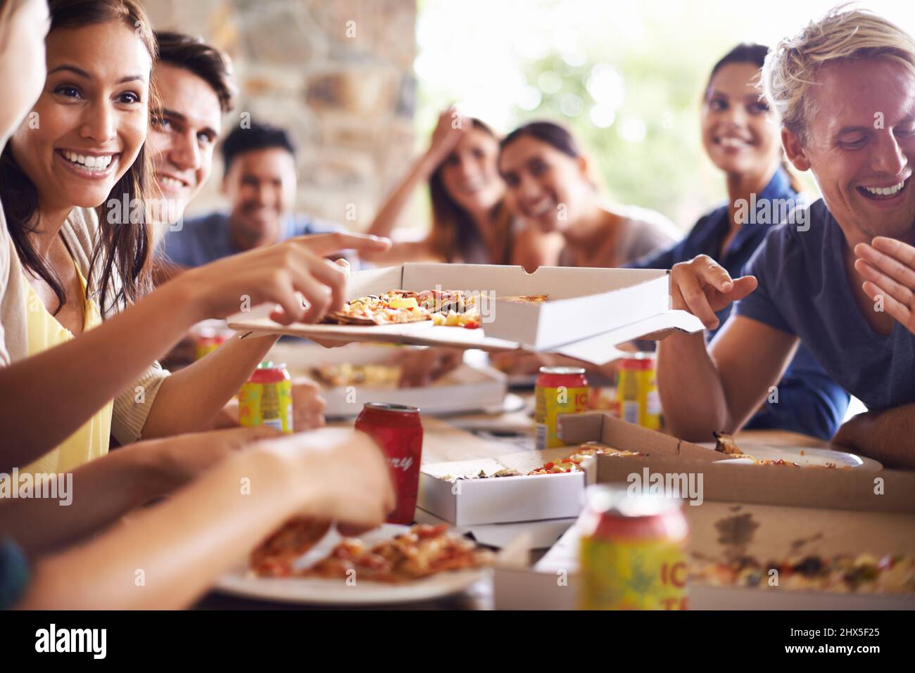 Good times with great pizza. Cropped shot of a group of friends enjoying pizza together. Stock Photo