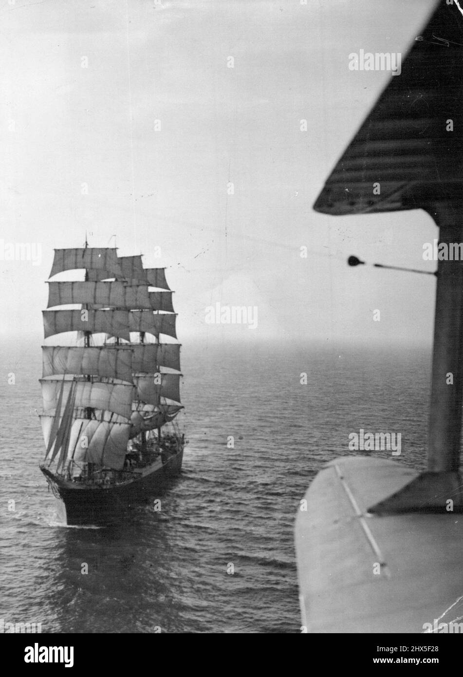 The Ancient and Modern With her white sails shining in the gleam of a wintry sun. The dour-masted 3,200-tons barque 'Pamir' made a perfect picture for our aerial photographer as she travelled up the English Channel at midday, December 21 - 79 day after leaving Wellington, New Zealand, 13,000 miles away. Included in her cargo of wools and tallow is a consignment of 64 cases of 'Patriotic' Christmas gifts - clothing. A 19th century barque, of the type which, made its precarious voyage under the captaincy of a careless drunkard. November 5, 1952. (Photo by Associated Press Photo) Stock Photo