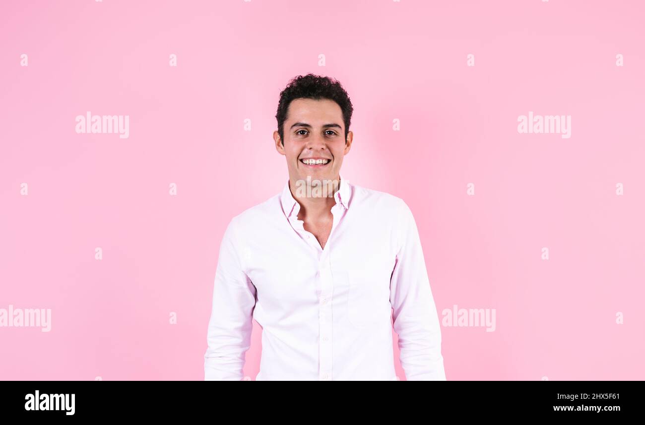 young hispanic business man wearing formal clothes smiling at camera on pink background in Mexico Latin America Stock Photo