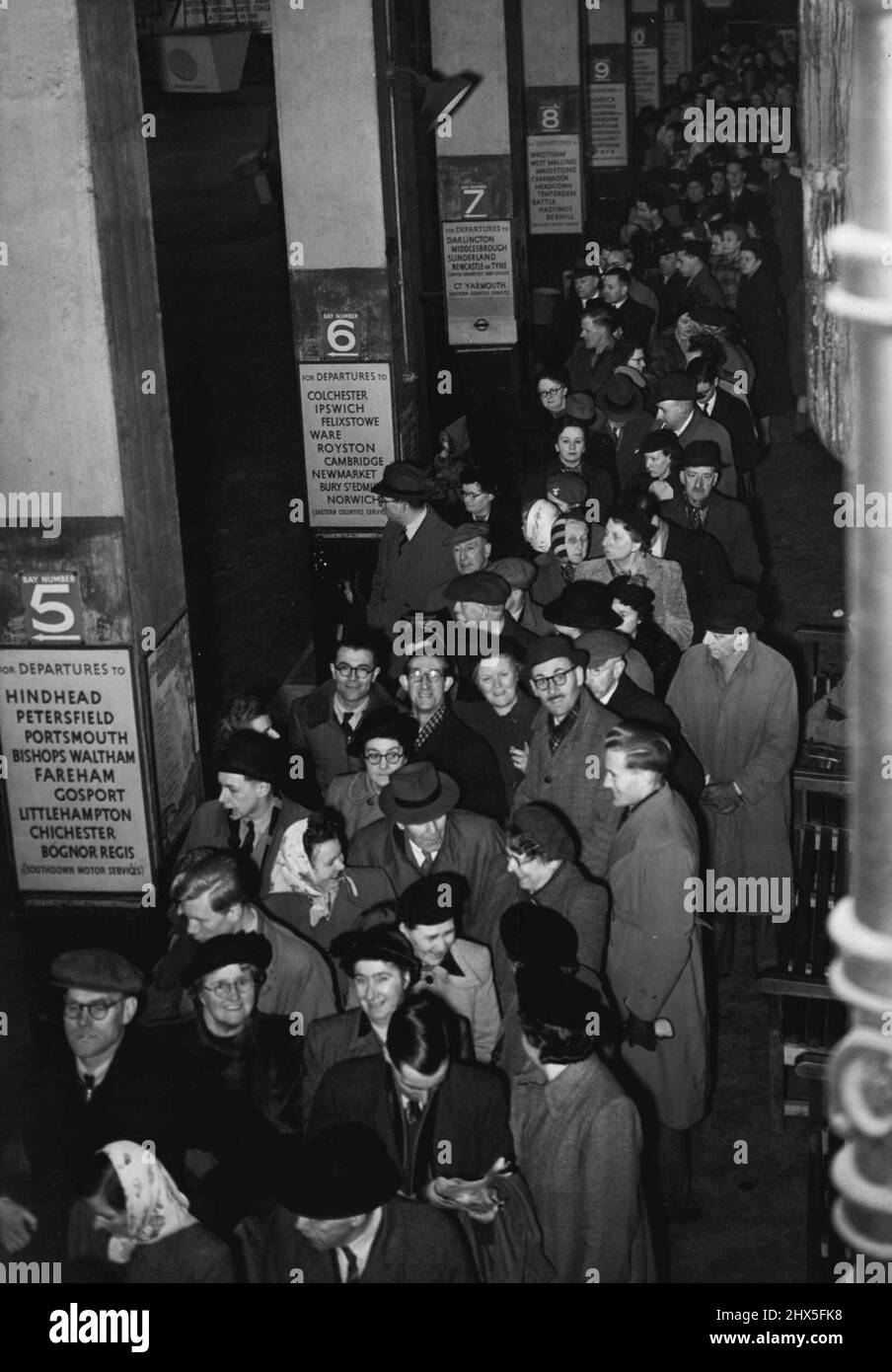 Queues Throng Coach Station As Booking Opens Today -- Looking down on the crowd of more than one thousand at the London Coach Station this morning (Thursday). This queue was for West Country only. With high rail fares and labour troubles clouding normal travel facilities, large crowds were at Victoria Coach station today (Thursday) the first day of holiday booking for the West Country area. February 22, 1951. (Photo by Fox Photos). Stock Photo