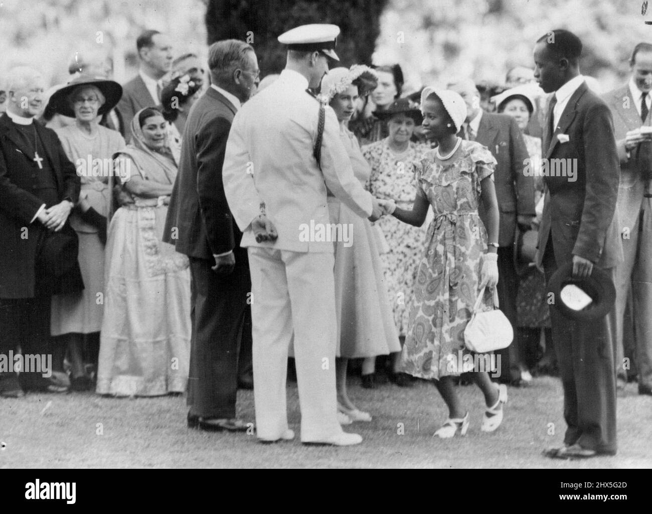 Princess In Nairobi -- Mrs. Nyanjom wife of Mr. ***** Nyanjom, Senior Co-Operative Inspector, being introduced ***** Princess Elizabeth during the Garden Party at Government House, Nairobi, one of the highlights of their Royal Highnesses visits to Kenya. April 02, 1952. Stock Photo