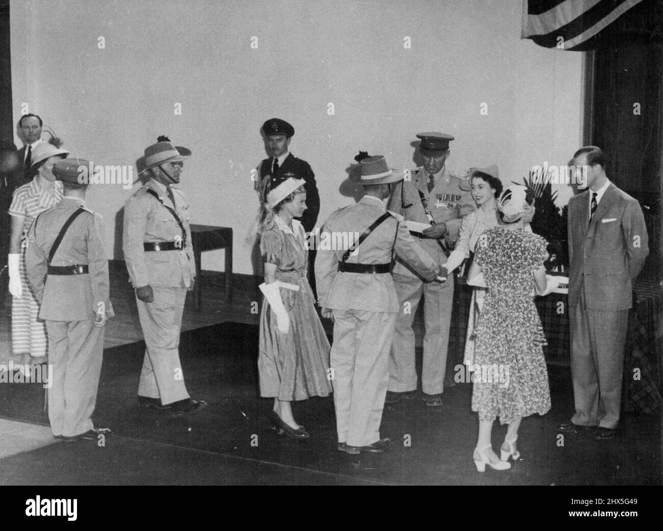 Princess In Nairobi -- Princess Elizabeth and the Duke of Edinburgh meet members of the Kenya Regiment during their visit to Nairobi. The Kenya regiment is the local territorial Army for the training of European Officers. Lt. Col. C.J. Valentine, OBE. is making the Introductions. February 14, 1952. Stock Photo