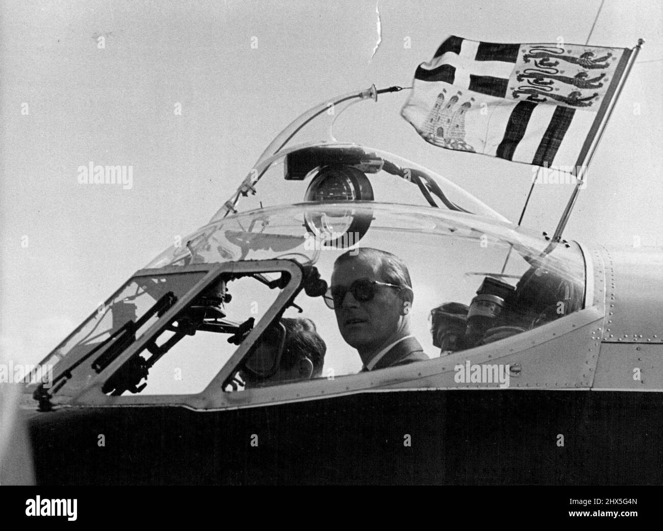 Duke Visits Rayon Centre -- The Duke at the Controls of his Dove Aircraft, flying of his Personal standard, prior to his return to London from the Manchester area. The Duke of Edinburgh, who is particularly interested in Developments in British science and Industry, visited the British Rayon centre at Northenden, near Manchester, yesterday. May 12, 1955. (Photo by Paul Popper Ltd.). Stock Photo