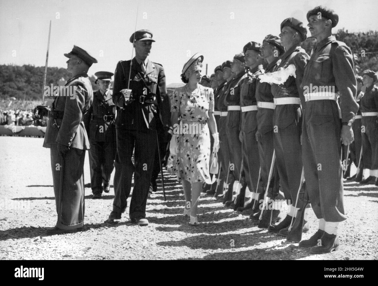 Princess Elizabeth Opens New South African Graving Dock -- Princess Elizabeth inspecting a guard of honor drawn from the Railways and Harbors Brigade. Princess Elizabeth performed her first public engagement on her own during the Royal family's tour of South Africa when she opened the new 'Princess Elizabeth' graving dock for ships up to 17,000 tons on the Buffalo River at East London by breaking a signal flag authorizing the South African Naval Forces Frigate 'Transvaal' to enter the dock. During the ceremony, the Princess received a gift of five large diamonds (estimated to be worth Stock Photo