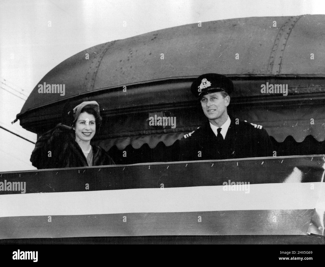 On Platform Of The Royal Train -- Princess Elizabeth and the Duke of Edinburgh on the Platform of the observation car which will take them across Canada. October 10, 1951. Stock Photo