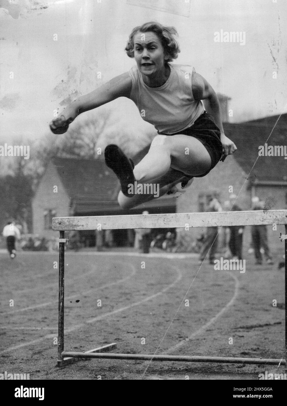 Best Foot Forward A jump ahead of the forthcoming athletic season is London girl hurdler Pamela French, of Spartan Ladies' athletic Club. She is seen taking a hurdle in fine style during practice on Tooting Bec Common, London. April 7, 1954. (Photo by Reuterphoto). Stock Photo