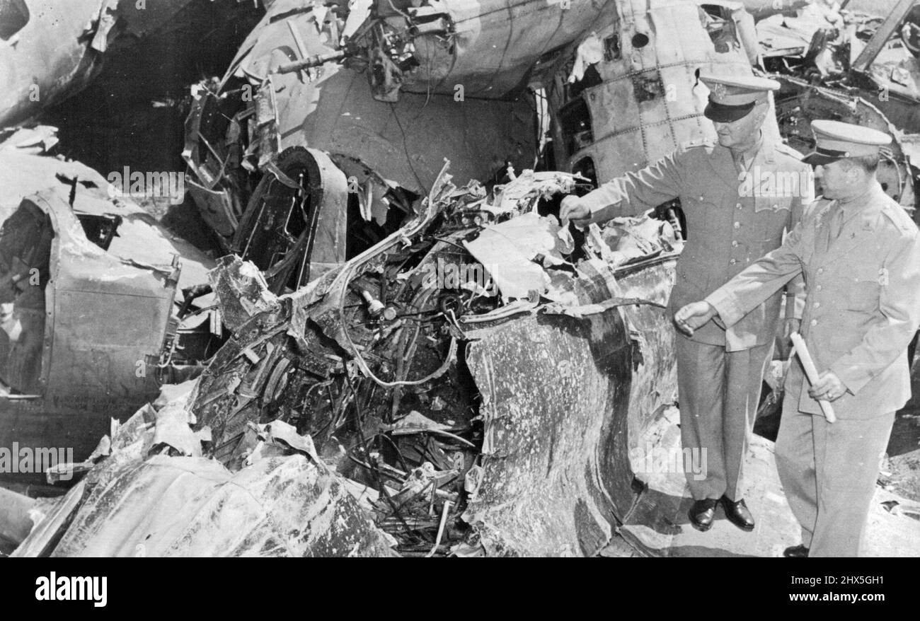 Wrecked Japanese Plane Sent to U.S. Major General T.A. Terry (left), commander of the Second Service Command of the U.S. Army Quartermaster Corps inspect the remains of a Japanese Zero shot down in the Pacific. Wreckage of hundreds of enemy fighter planes is being sent from Pacific battlefields to the U.S. for reclamation. October 24, 1943. Stock Photo